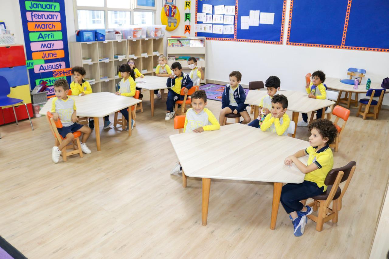 Brightly colored classroom at IVY STEM International School with young children wearing coordinated outfits. The room is well-lit and features educational materials and child-sized furniture, creating a learning-friendly atmosphere for young students.