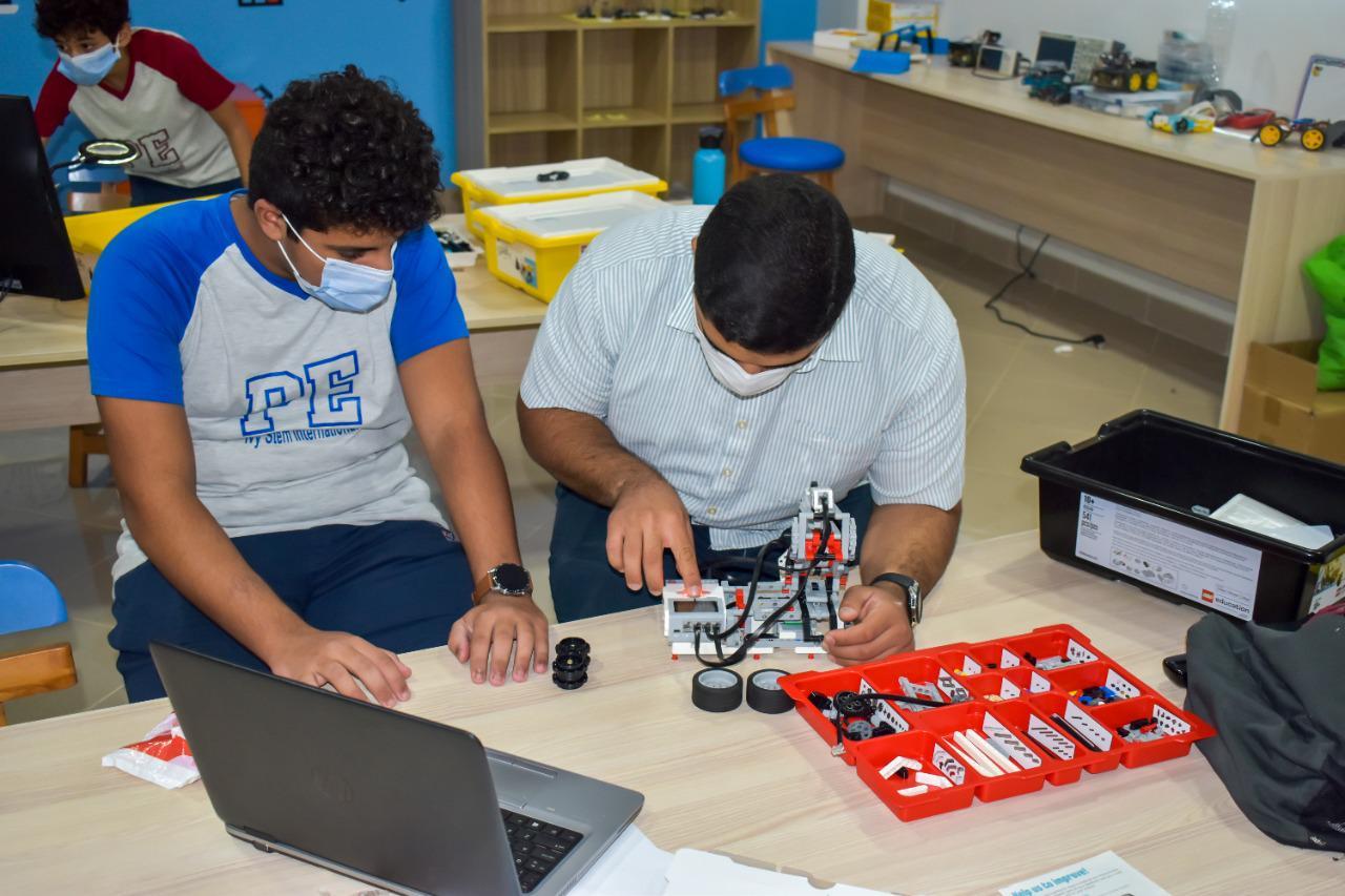 Students engaged in robotics and engineering activities at IVY STEM International School's robotics lab, learning about STEM subjects through hands-on projects.