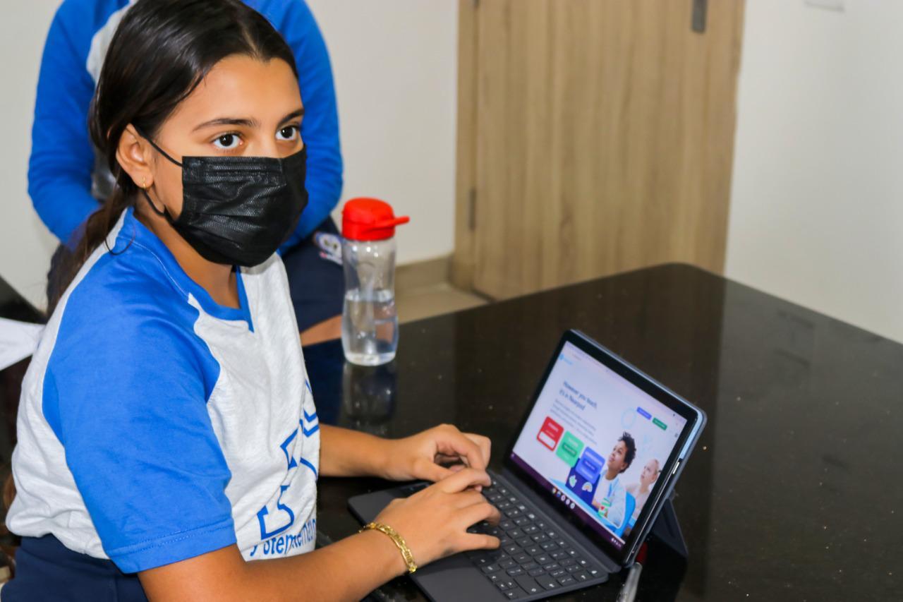 A student from IVY STEM International School engaged in educational activities on a laptop, using the school's web-based platform for learning and registration.