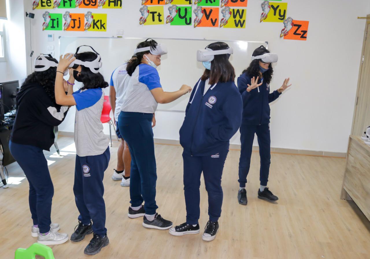 The image showcases students at IVY STEM International School engaging in a virtual reality (VR) experience, utilizing VR headsets and interacting with a virtual environment. The school's technology-driven approach to education fosters immersive learning experiences.