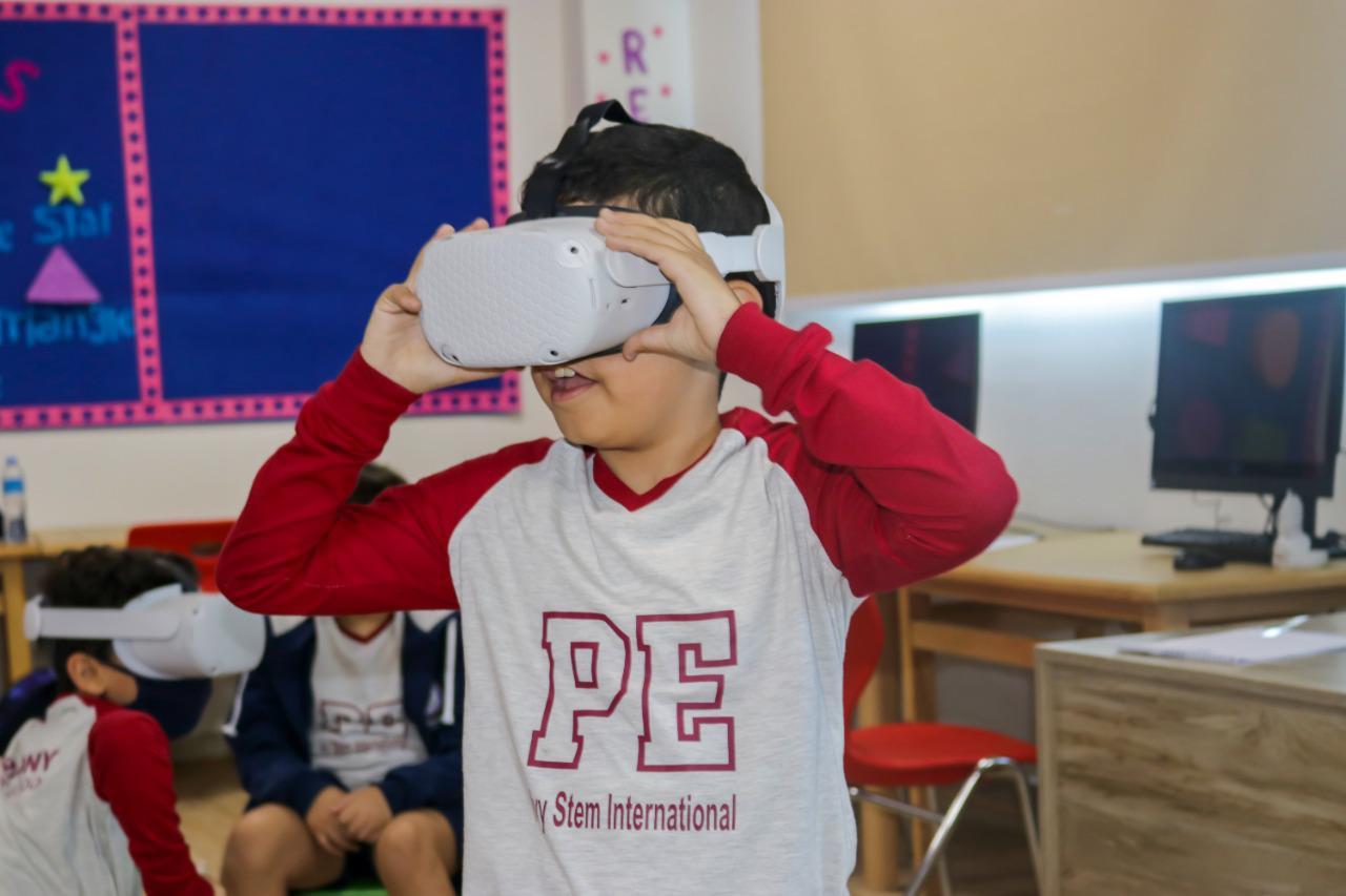 Children at IVY STEM International School engaged in a VR classroom activity, wearing VR headsets and exploring educational content. The use of VR technology enhances the learning experience and reflects the school's commitment to innovative teaching methods.
